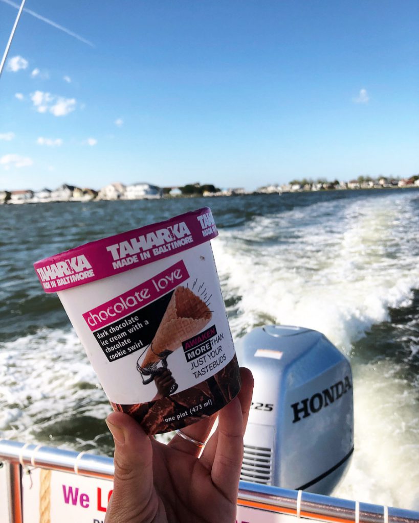 Ice Cream being held up on a boat ride