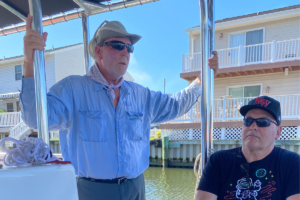 MD Coastal Bay volunteer talking and educating people about MD Lower Eastern shore, while aboard an OC Bay Hopper boat