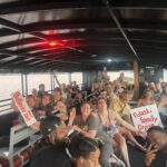 Group of people on a boat laughing and having a good time